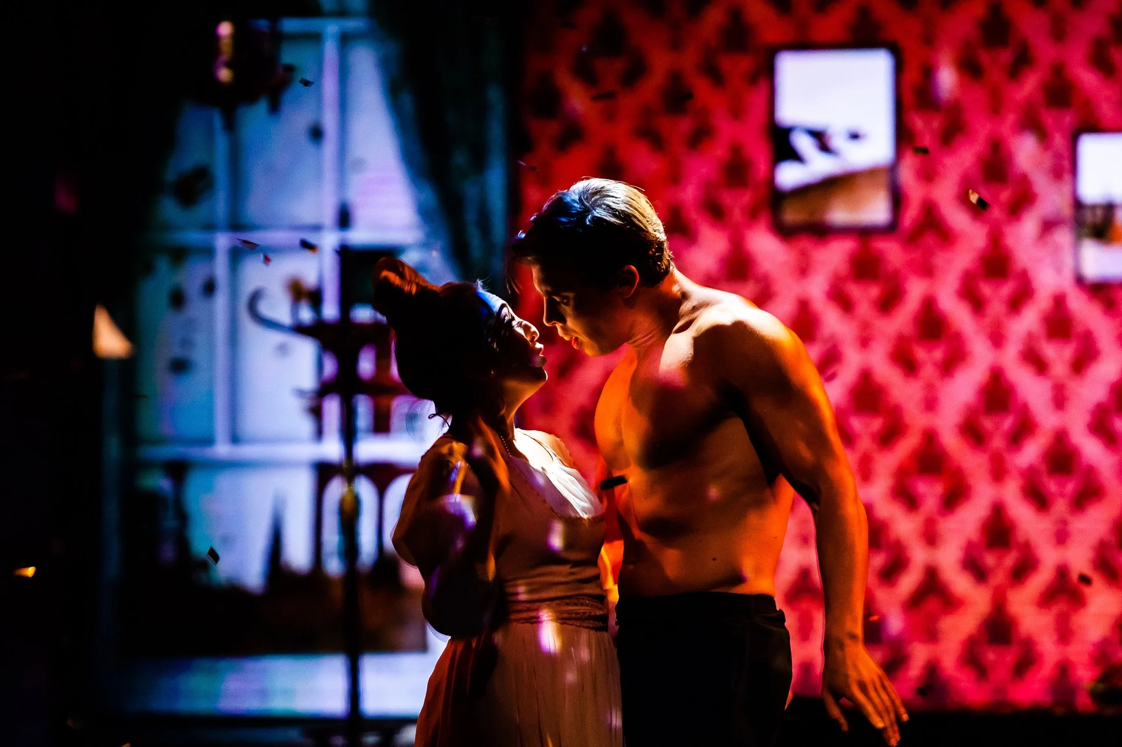 Close theatrical moment in deep red light