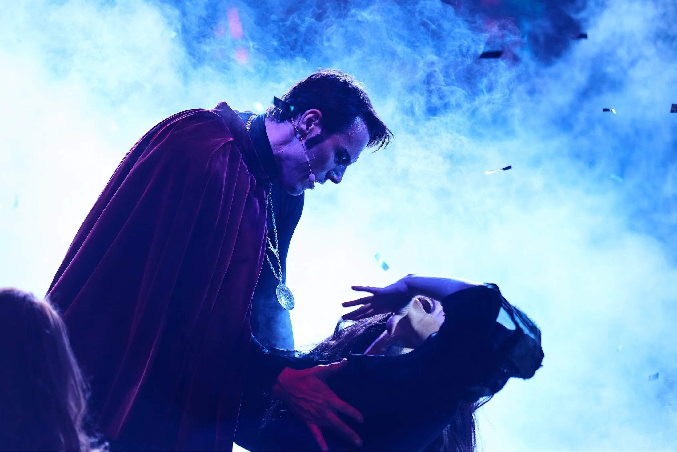 Intimate blue theatrical scene from Faust