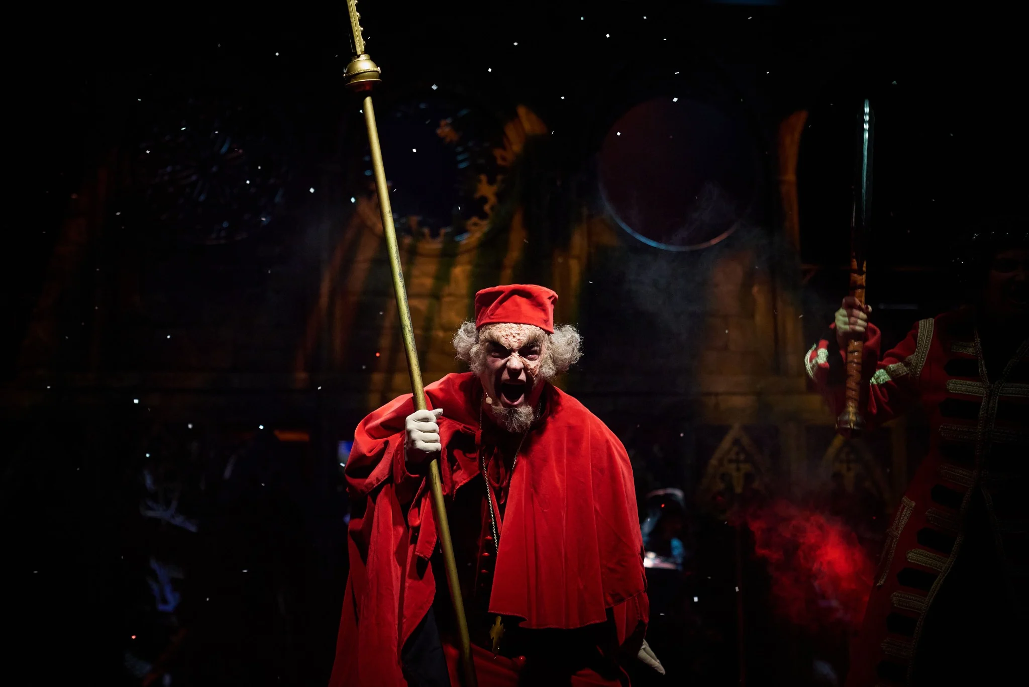 Theatre photograph from Faust: a bishop in red stage costume